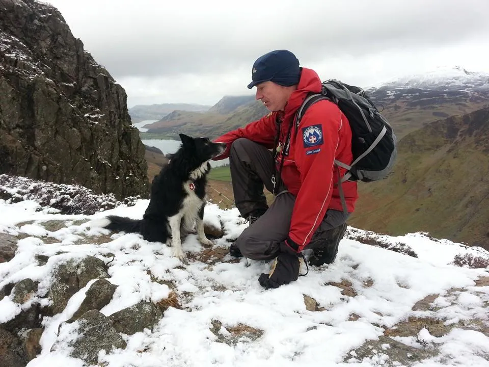 Ian Bertie in Mountain Rescue kit with Search Dog Ronnie in the Lake District